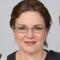 Joyful white adult female with medium  brown hair and brown eyes