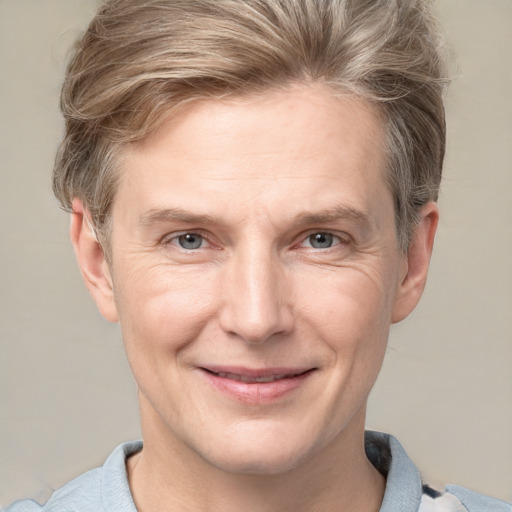 Joyful white adult male with short  brown hair and grey eyes