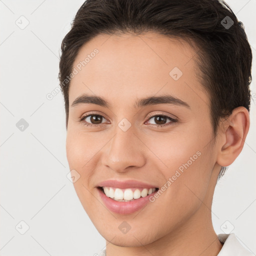 Joyful white young-adult female with short  brown hair and brown eyes