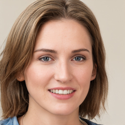 Joyful white young-adult female with medium  brown hair and green eyes