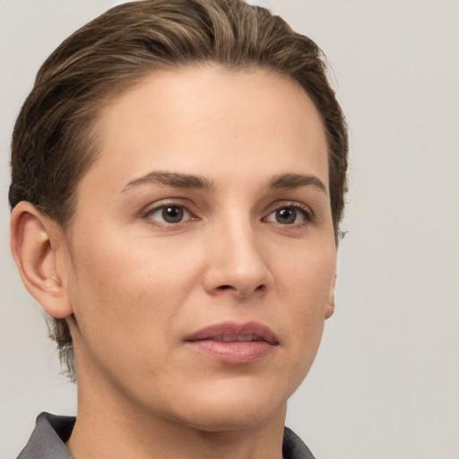 Joyful white young-adult female with short  brown hair and grey eyes