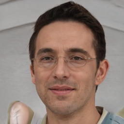 Joyful white adult male with short  brown hair and brown eyes