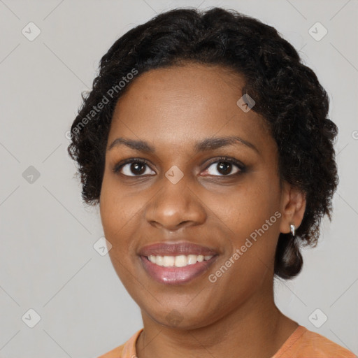 Joyful black young-adult female with short  brown hair and brown eyes