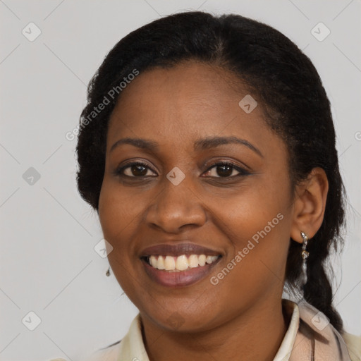 Joyful black young-adult female with long  black hair and brown eyes