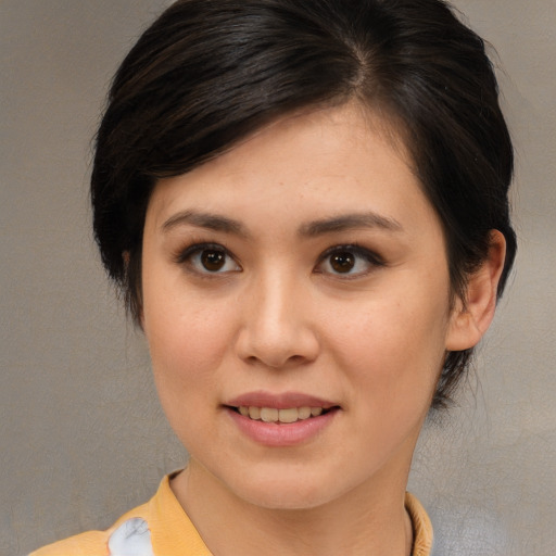 Joyful asian young-adult female with medium  brown hair and brown eyes