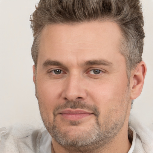 Joyful white adult male with short  brown hair and brown eyes