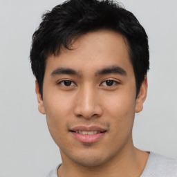 Joyful asian young-adult male with short  black hair and brown eyes