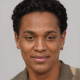 Joyful black adult male with short  black hair and brown eyes