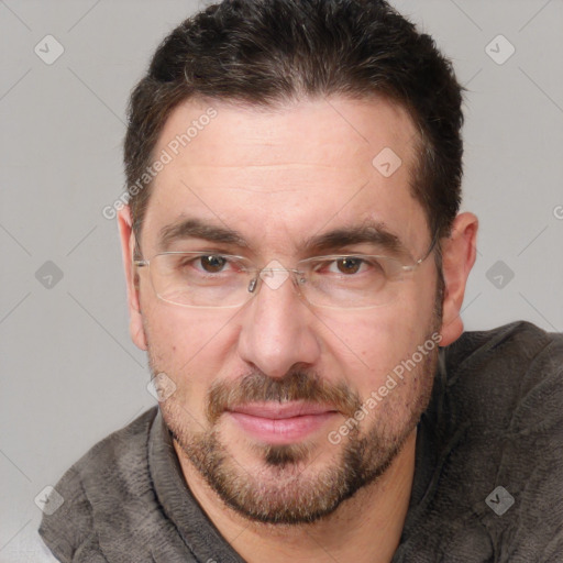 Joyful white adult male with short  brown hair and brown eyes