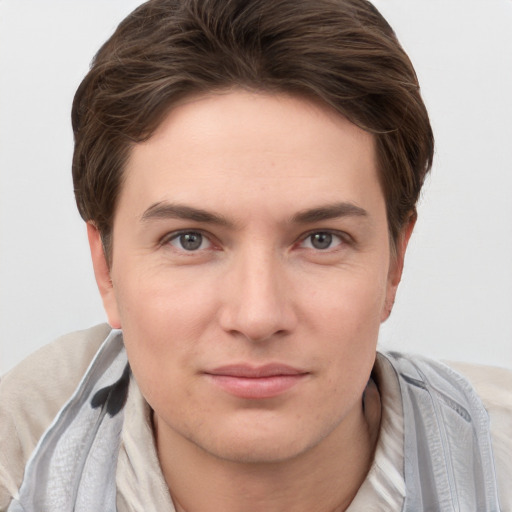 Joyful white young-adult female with short  brown hair and grey eyes