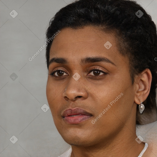 Joyful black young-adult female with short  black hair and brown eyes