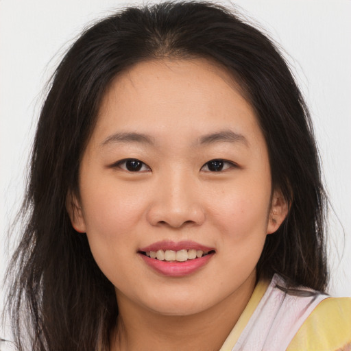 Joyful asian young-adult female with long  brown hair and brown eyes