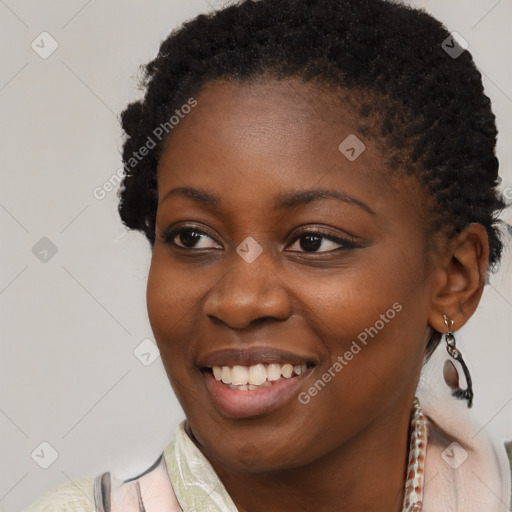 Joyful black young-adult female with short  brown hair and brown eyes