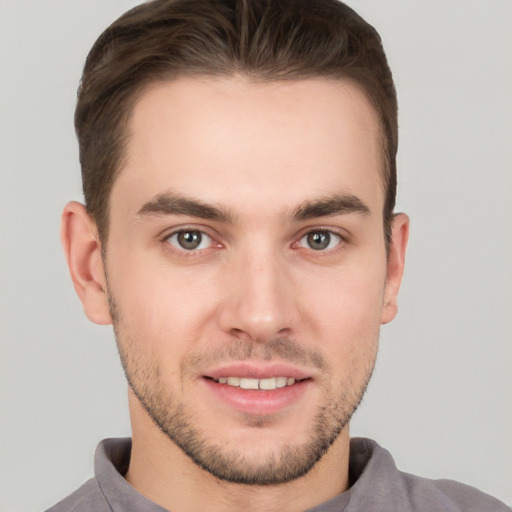 Joyful white young-adult male with short  brown hair and brown eyes