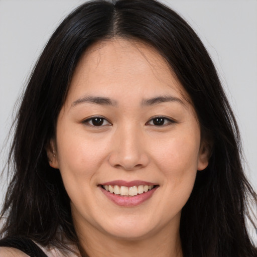 Joyful white young-adult female with long  brown hair and brown eyes