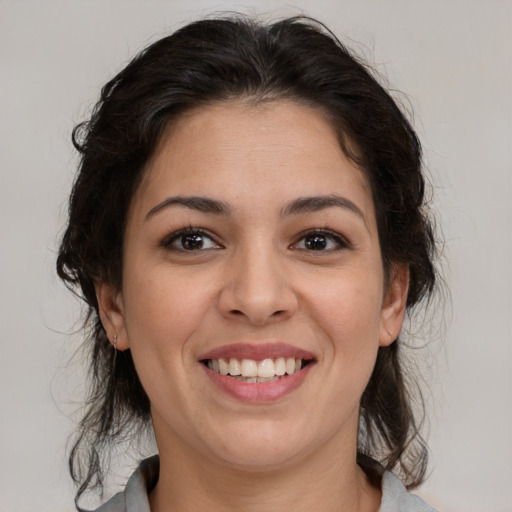 Joyful latino young-adult female with medium  brown hair and brown eyes