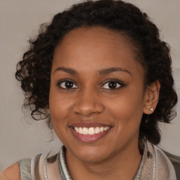 Joyful black young-adult female with medium  brown hair and brown eyes