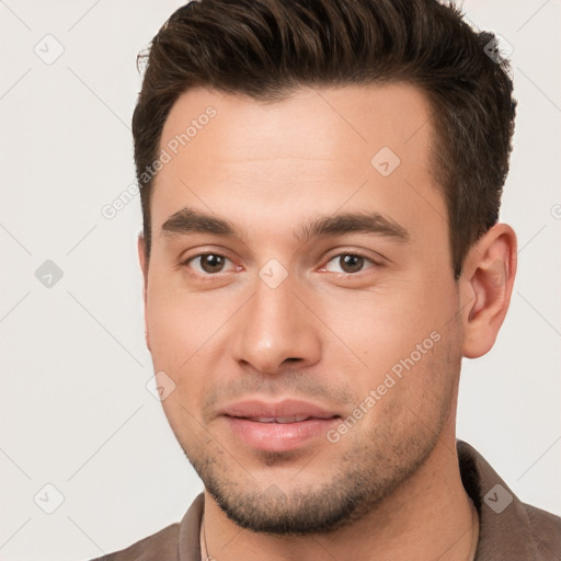 Joyful white young-adult male with short  brown hair and brown eyes