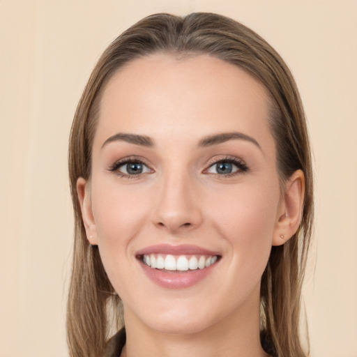 Joyful white young-adult female with long  brown hair and blue eyes