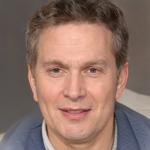 Joyful white middle-aged male with short  brown hair and brown eyes