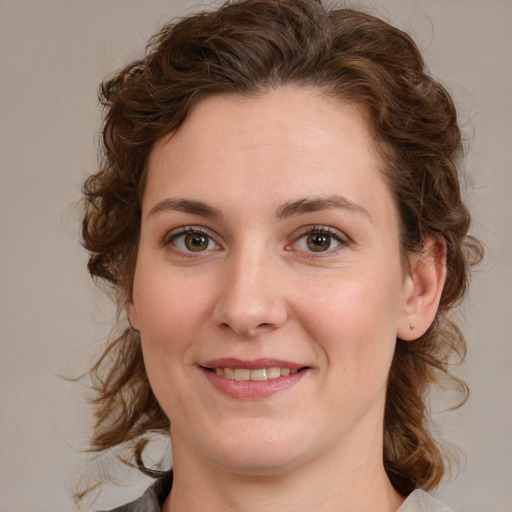 Joyful white young-adult female with medium  brown hair and green eyes