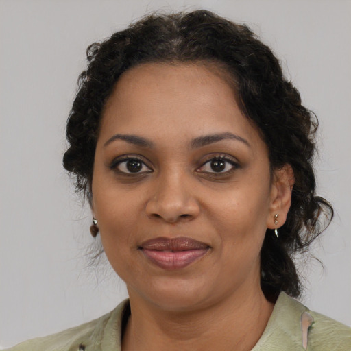 Joyful black young-adult female with medium  brown hair and brown eyes