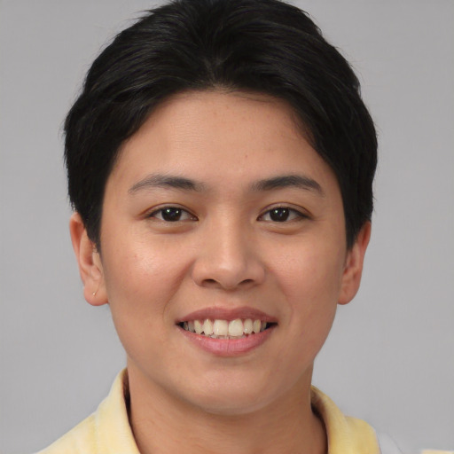 Joyful asian young-adult female with short  brown hair and brown eyes