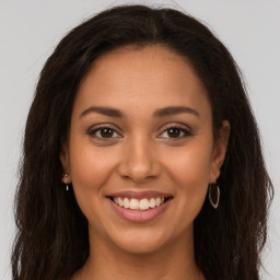 Joyful latino young-adult female with long  brown hair and brown eyes