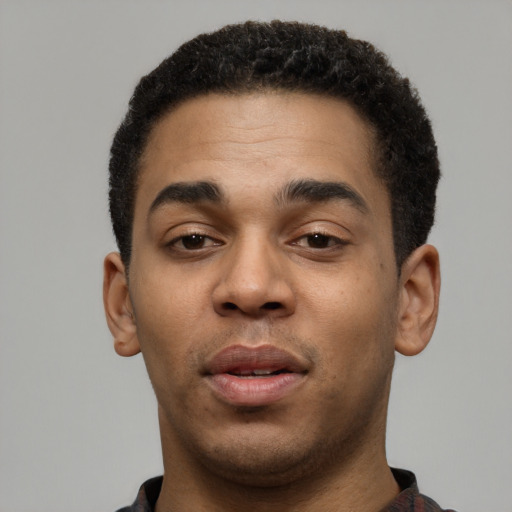 Joyful latino young-adult male with short  brown hair and brown eyes