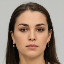 Neutral white young-adult female with long  brown hair and brown eyes