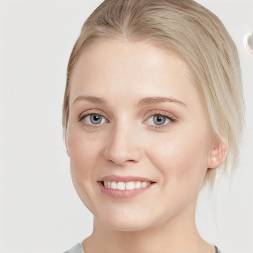 Joyful white young-adult female with medium  brown hair and blue eyes