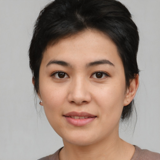 Joyful asian young-adult female with medium  black hair and brown eyes