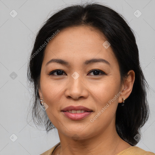 Joyful asian adult female with medium  brown hair and brown eyes