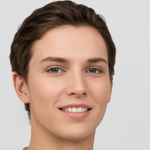 Joyful white young-adult female with short  brown hair and grey eyes