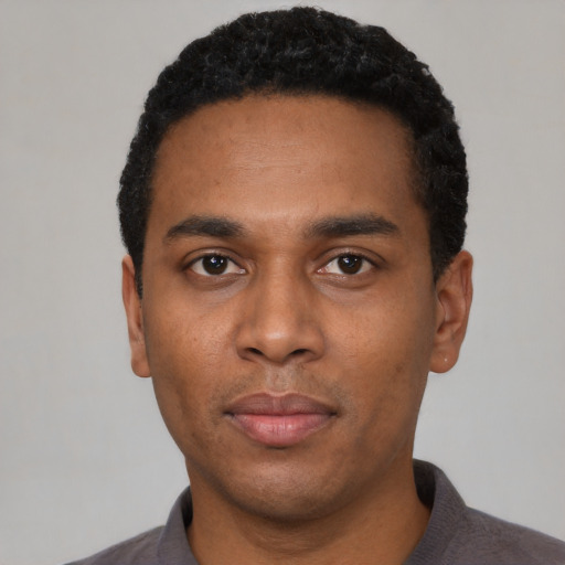 Neutral black young-adult male with short  black hair and brown eyes
