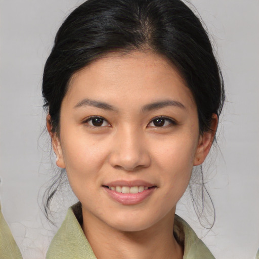Joyful asian young-adult female with medium  brown hair and brown eyes