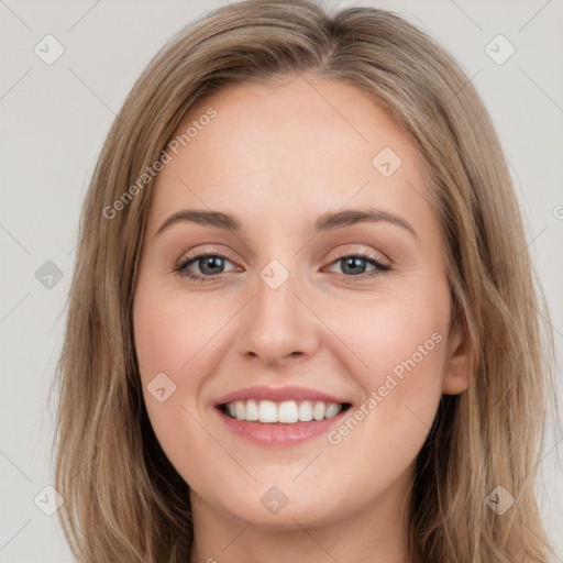 Joyful white young-adult female with long  brown hair and green eyes