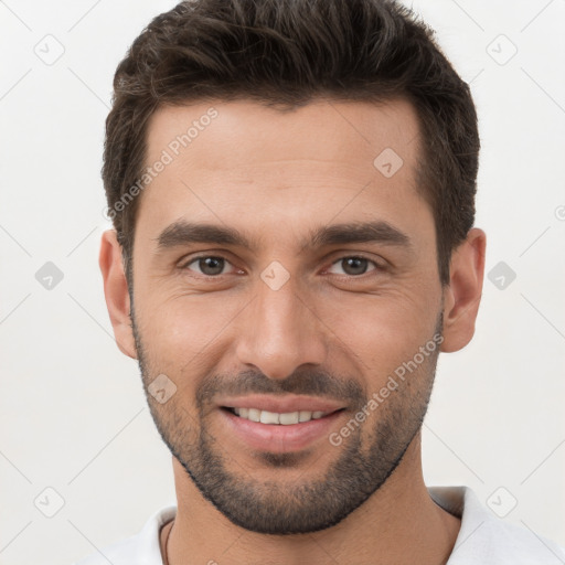 Joyful white young-adult male with short  brown hair and brown eyes