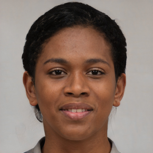 Joyful black young-adult female with short  brown hair and brown eyes