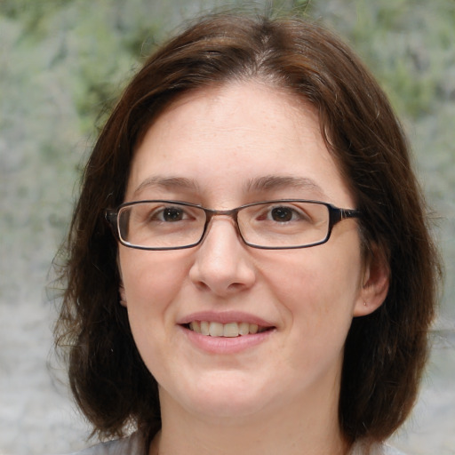 Joyful white adult female with medium  brown hair and brown eyes