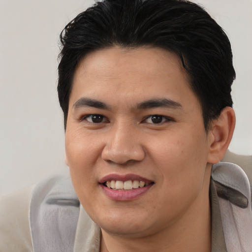 Joyful asian young-adult male with short  brown hair and brown eyes