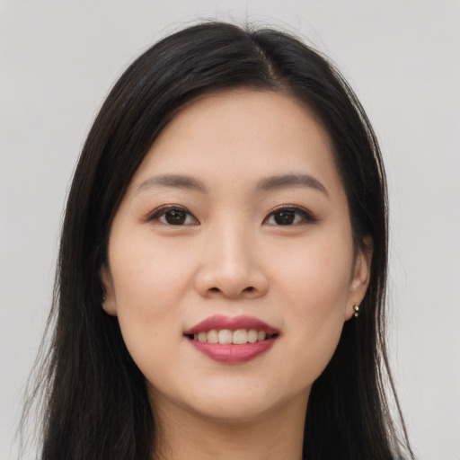 Joyful asian young-adult female with long  brown hair and brown eyes
