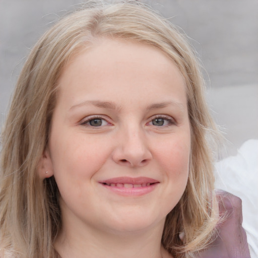 Joyful white young-adult female with medium  brown hair and blue eyes