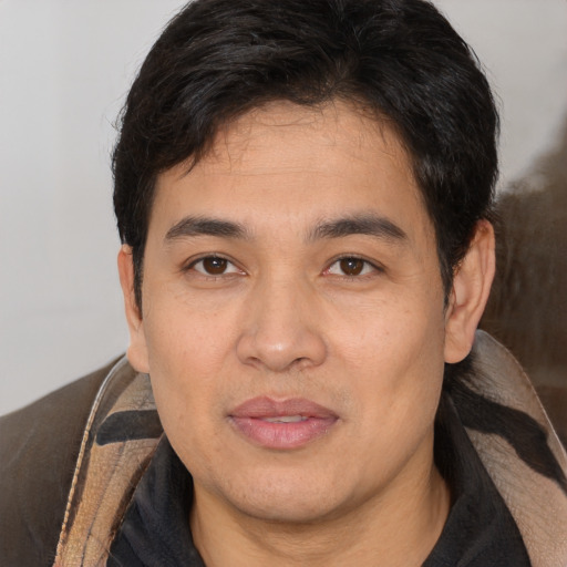 Joyful white adult male with short  black hair and brown eyes