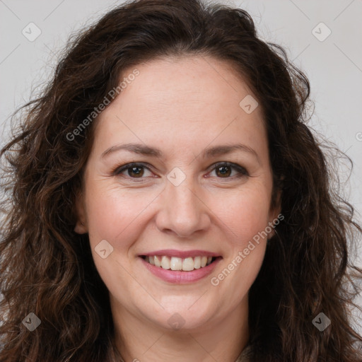 Joyful white adult female with long  brown hair and brown eyes