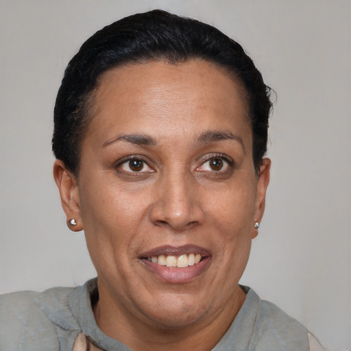 Joyful latino adult female with short  black hair and brown eyes