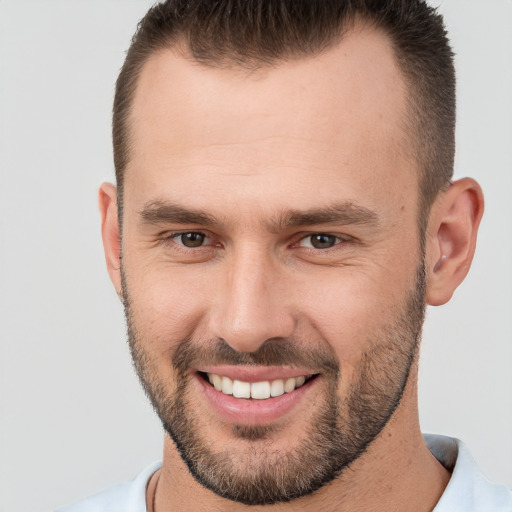 Joyful white young-adult male with short  brown hair and brown eyes