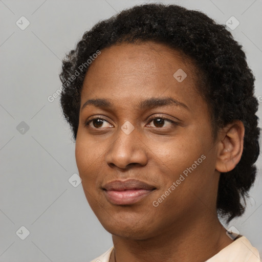 Joyful black young-adult female with short  black hair and brown eyes