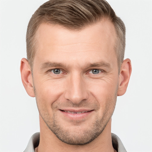 Joyful white adult male with short  brown hair and grey eyes