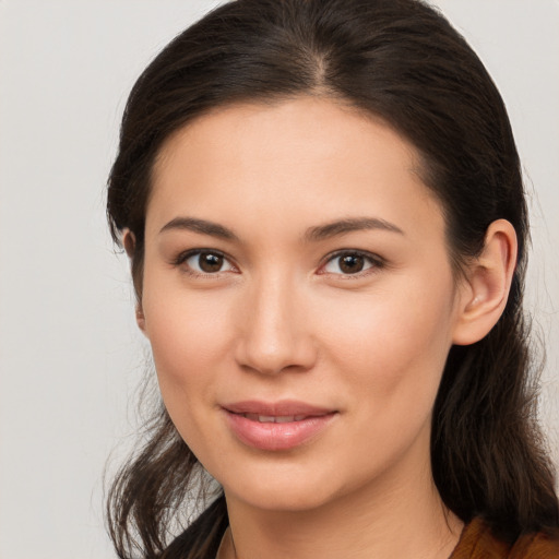 Joyful white young-adult female with long  brown hair and brown eyes